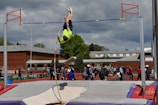 A young athlete vaulting over a bar in the covered parkour training area at Parkour Shard.