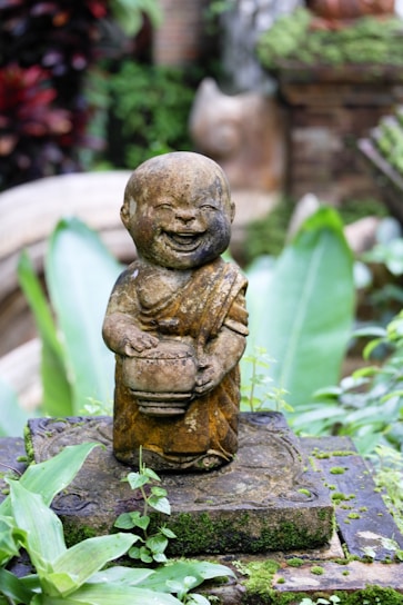 A serene portrait of the monk smiling gently in a peaceful natural setting.