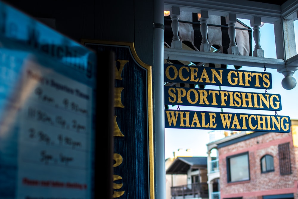 Ocean Gifts Sportfishing Whale Watching signage hanged on store ceiling