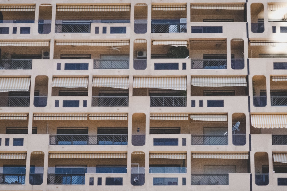 Persona que toma una foto de un edificio de hormigón blanco