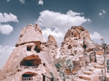 mountain with carved houses during daytime