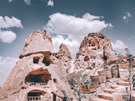 mountain with carved houses during daytime