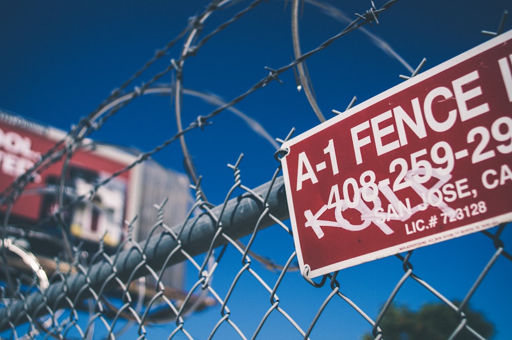 closeup photography of red A-1 Fence signage