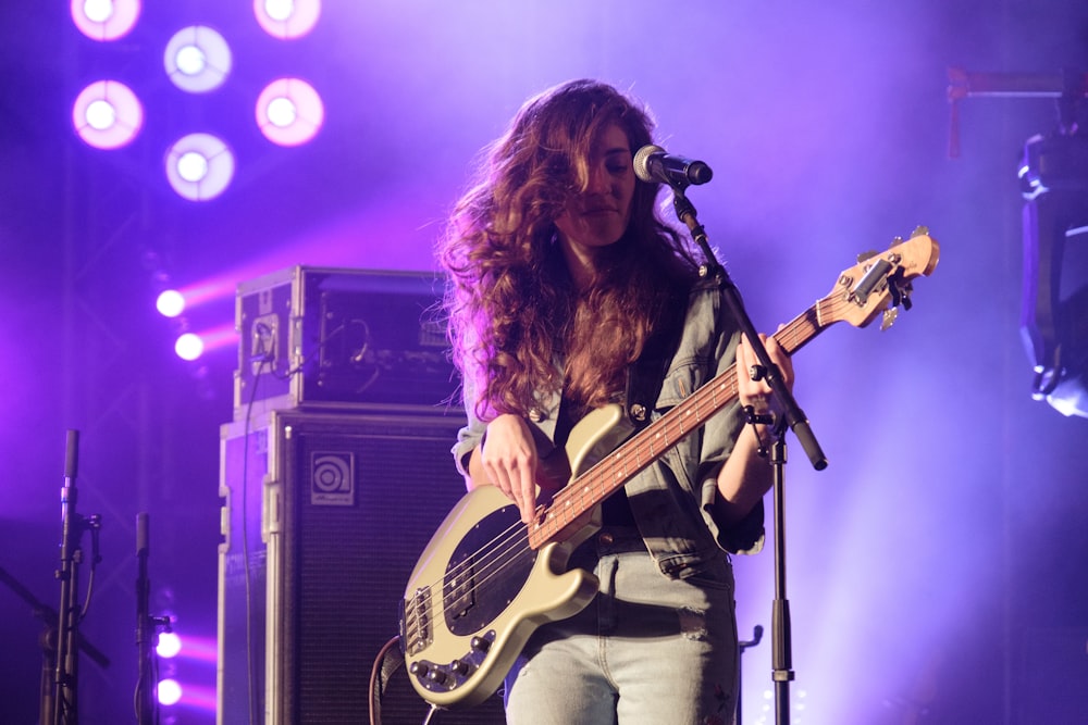 woman playing guitar in theater