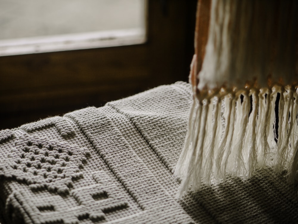 person taking photo of gray textile