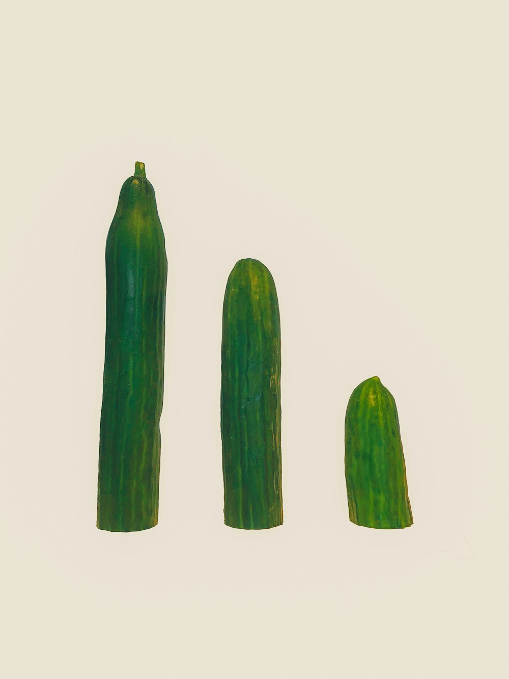 three cucumbers on white surface