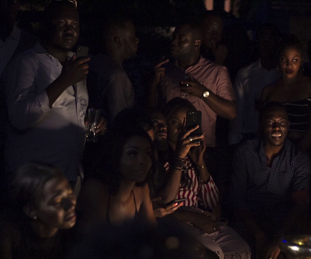 people taking photos on dark room