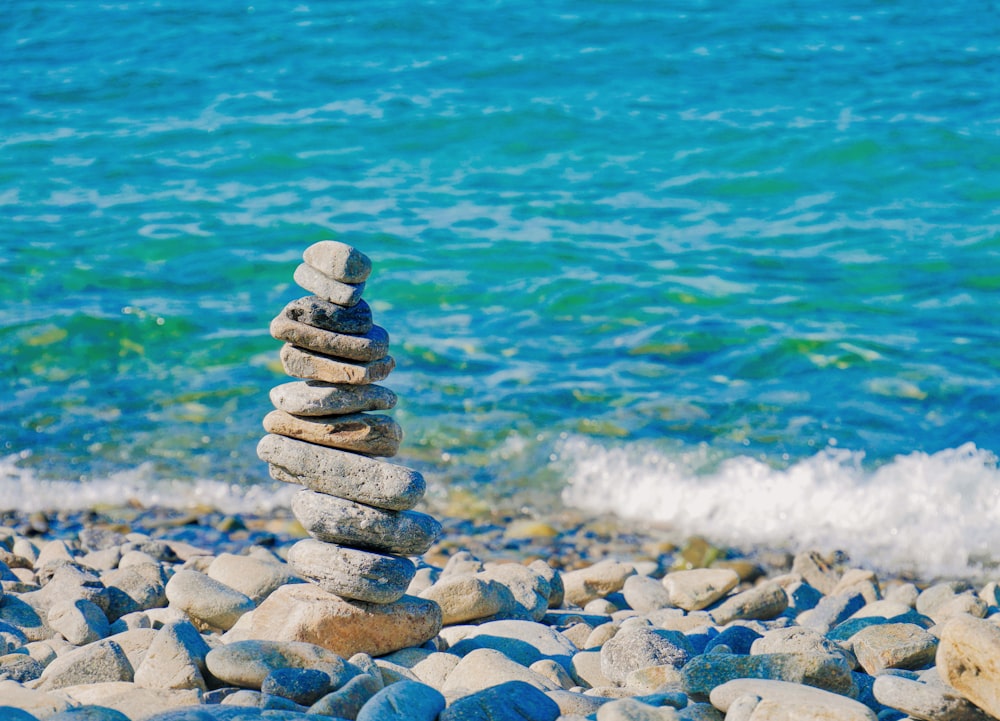 piled rock beside shoreline