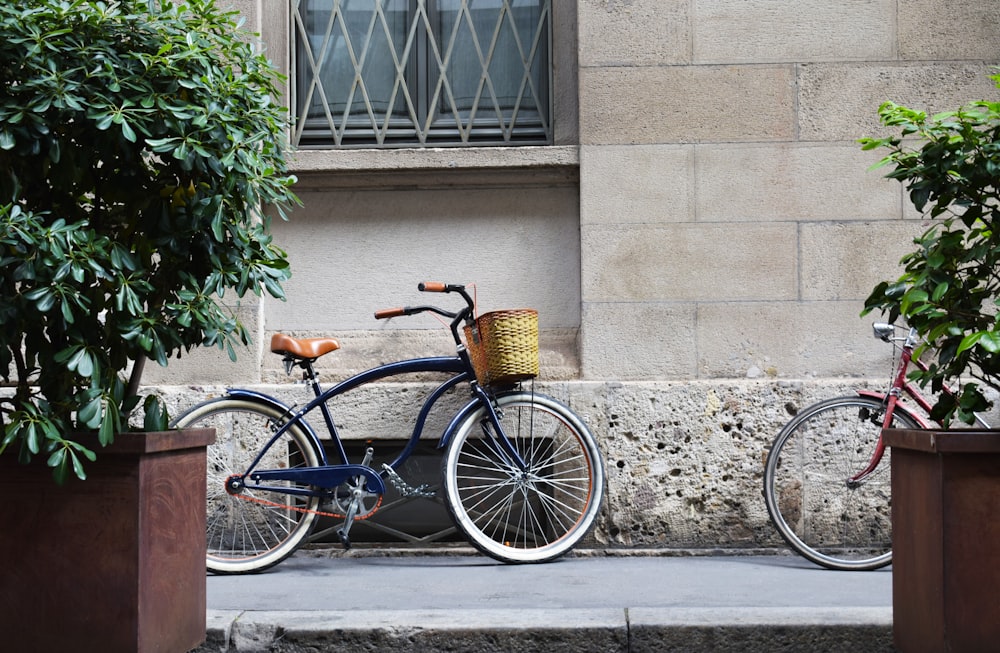 blue bicycle parked upright near building