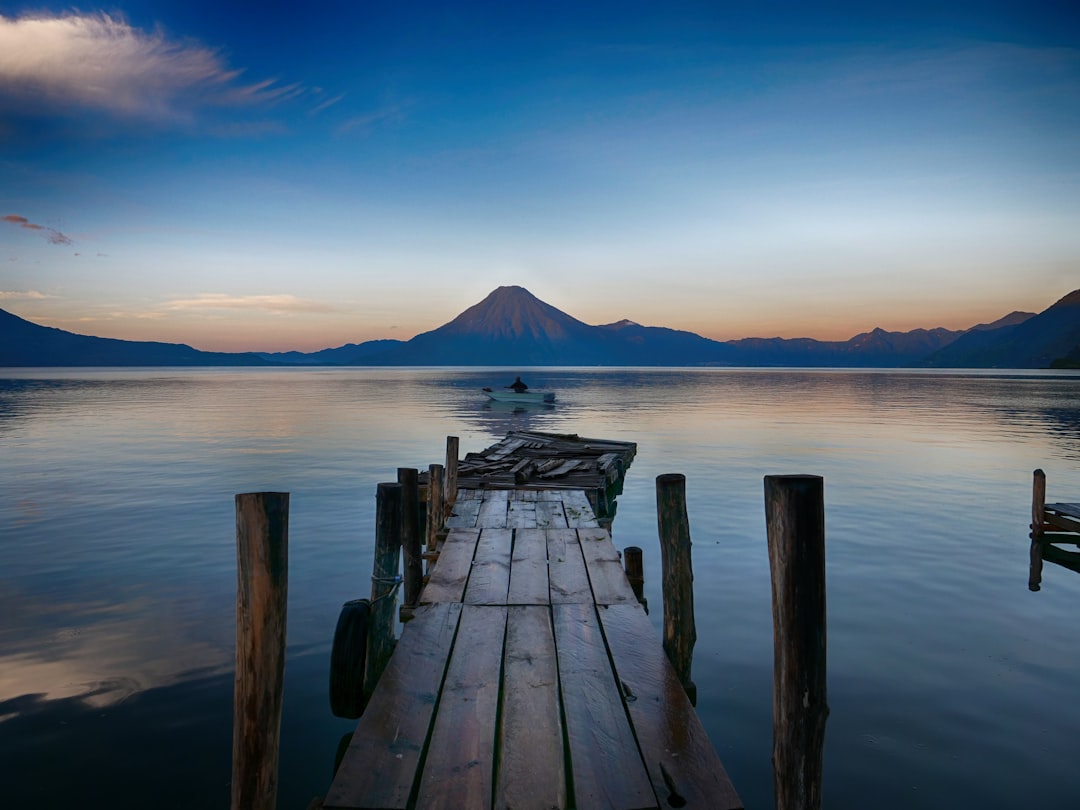 dock near water with cone mountain,