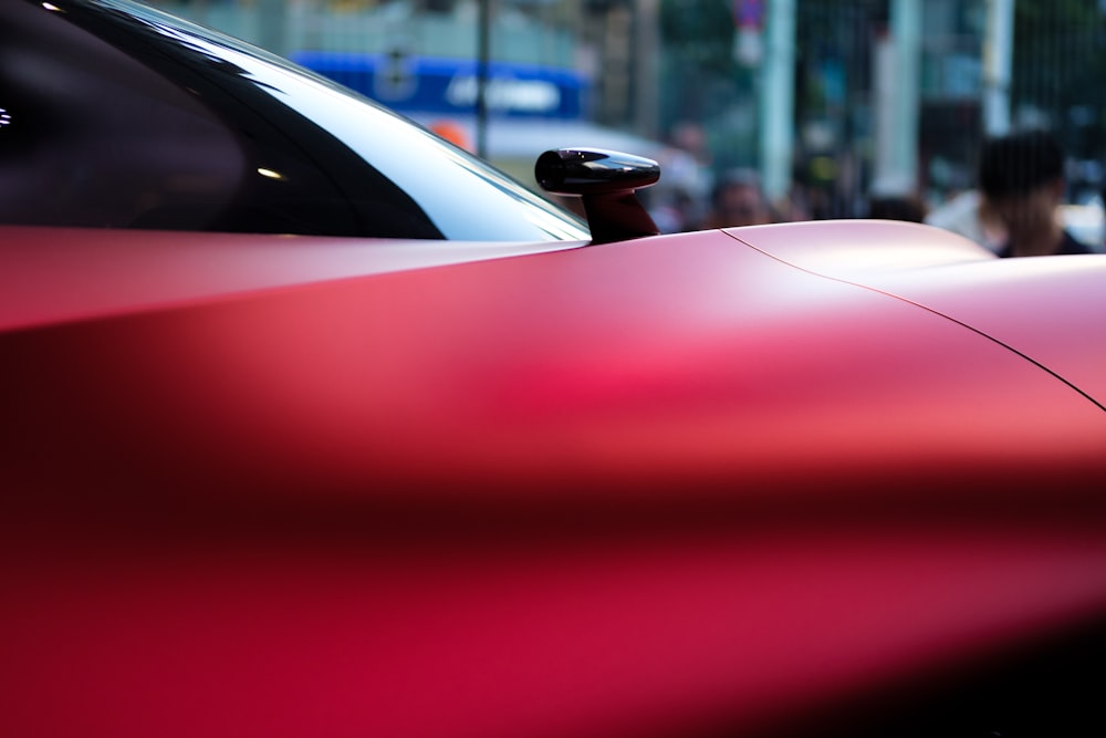 a red sports car parked on the side of the road