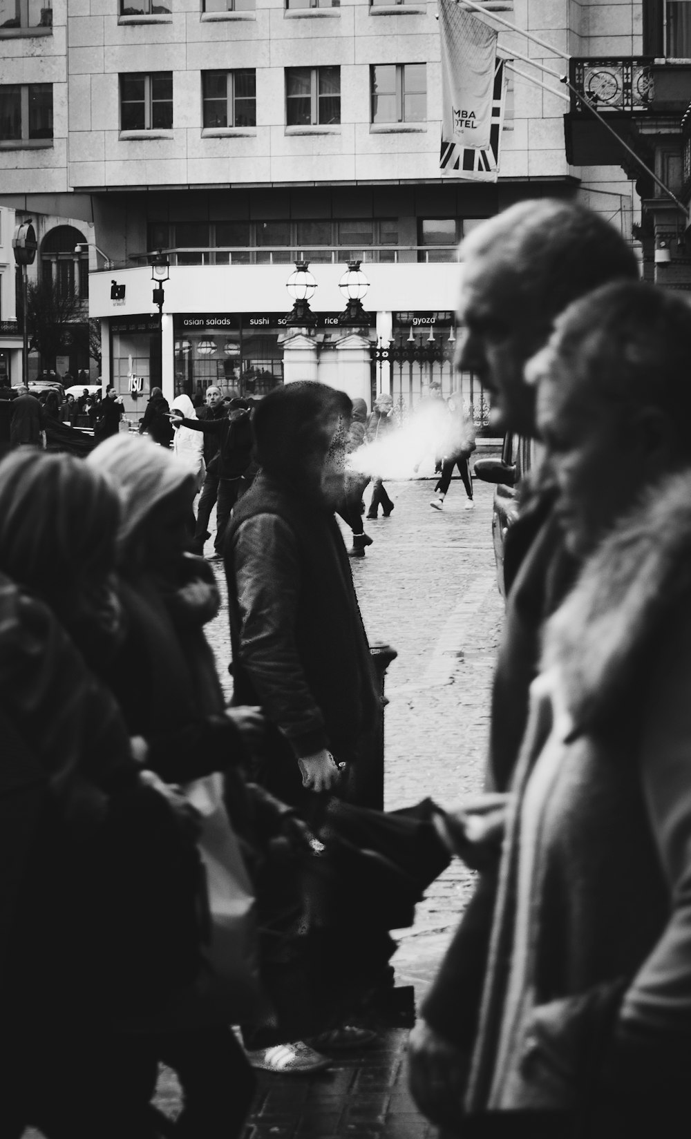 group of people on road grayscale photo