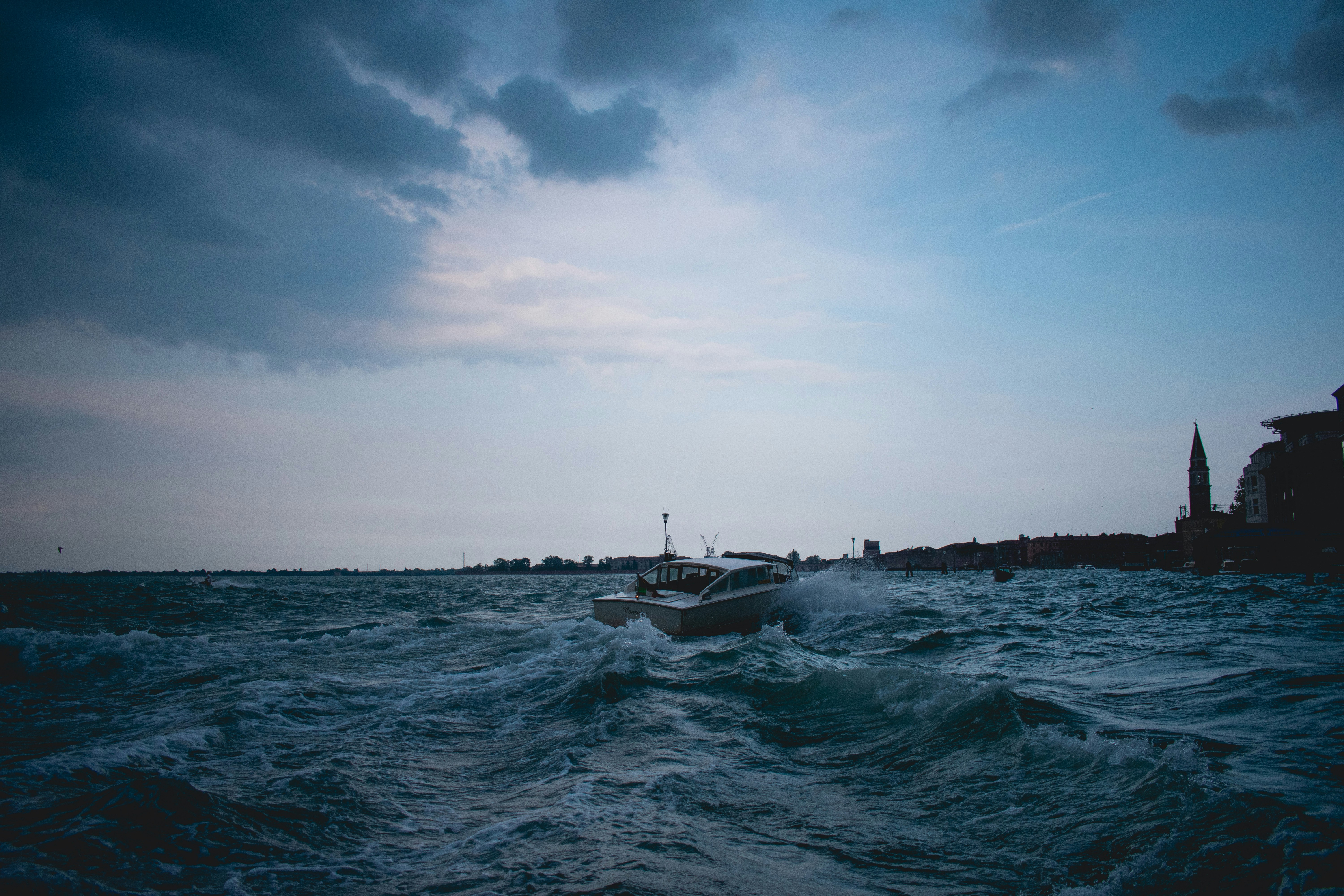 ship on body of water under dark sky