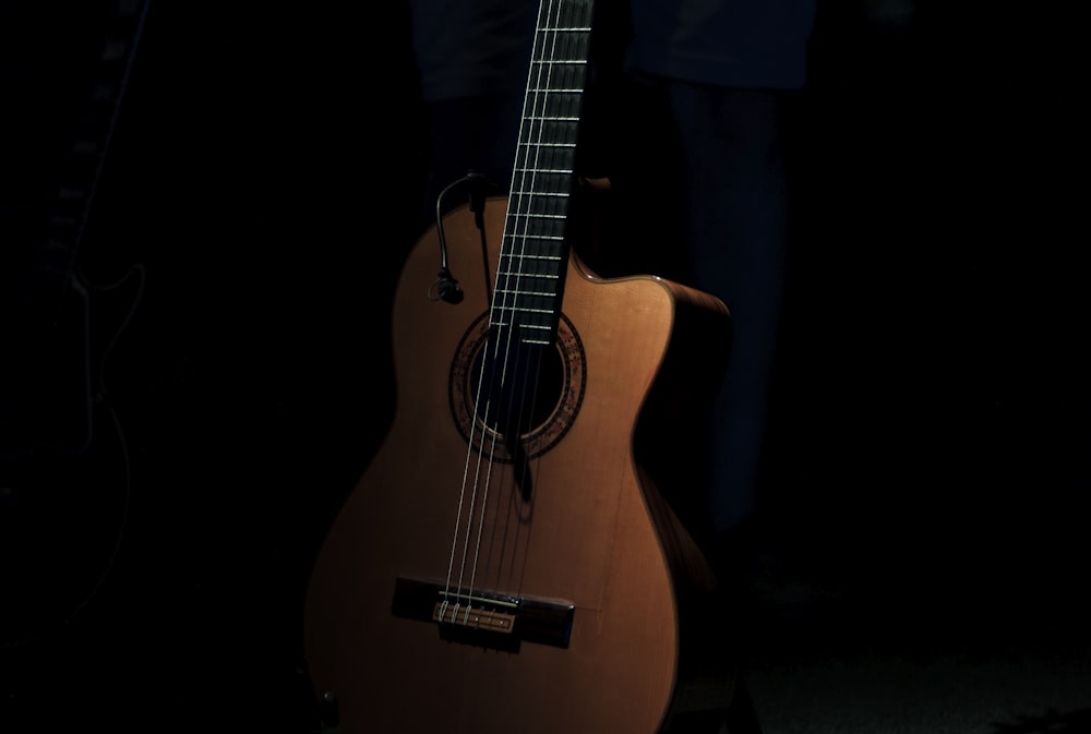 brown cutaway acoustic guitar