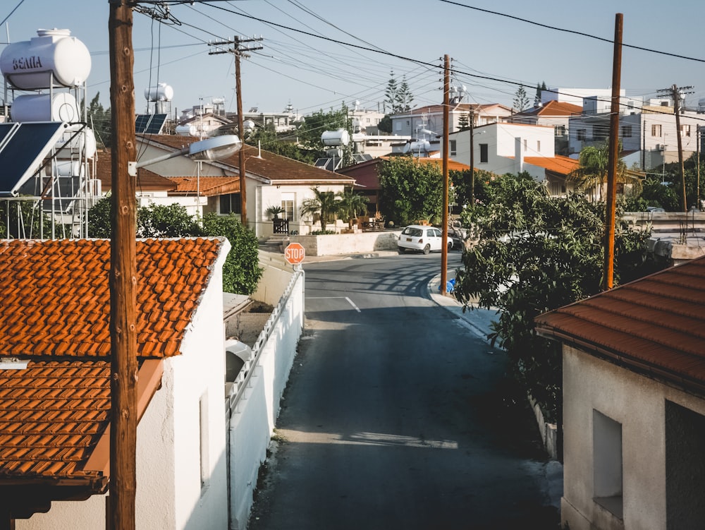 gray concrete road beside houses