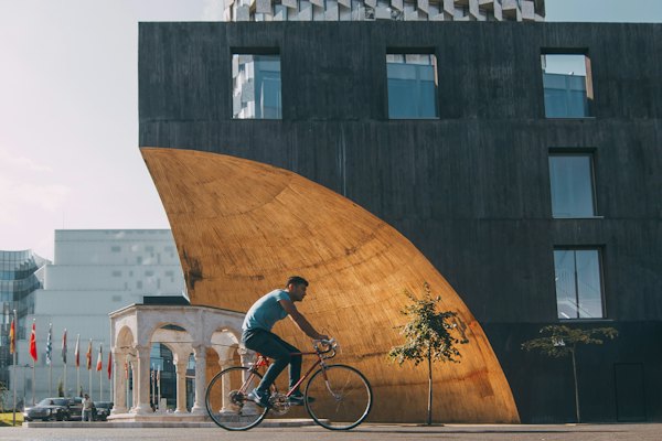 Man riding bicycle near building — Tirana, Albania