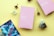 A layout on a yellow background featuring two pink cards with motivational phrases in Spanish, surrounded by small white flowers, brown dried flowers, crystals, and a cosmic-themed card.