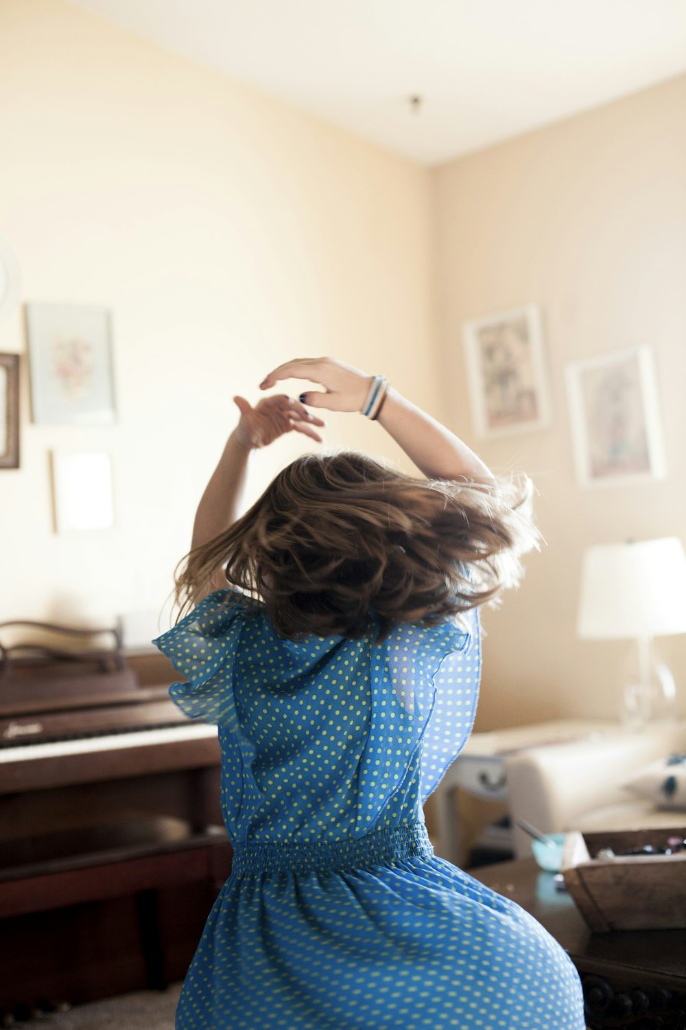 girl twirling around room