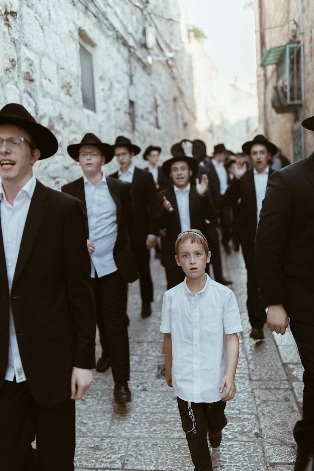 group of men walking on concrete road