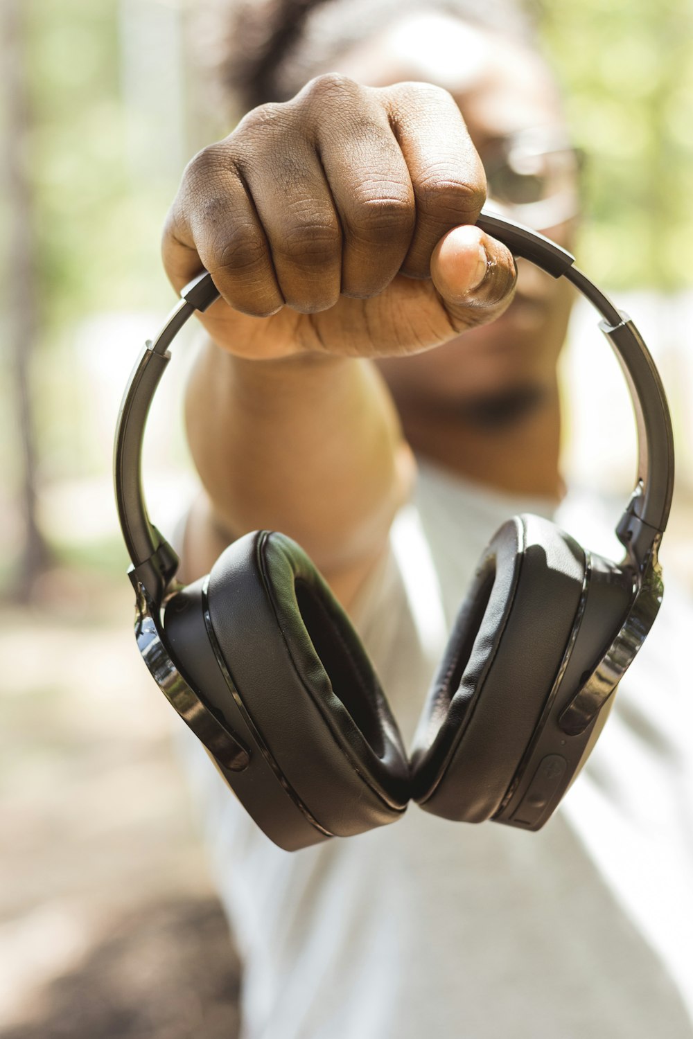 man holding wireless headphones