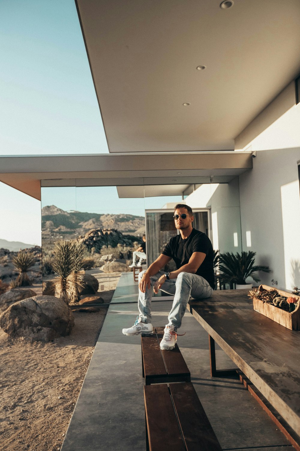 photo of man sitting on wooden board