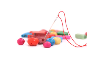 Close-up of colorful yarns and beads spilling from a craftiva DIY kit box.