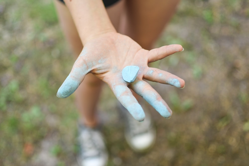 toddler showing blue chalk on hand