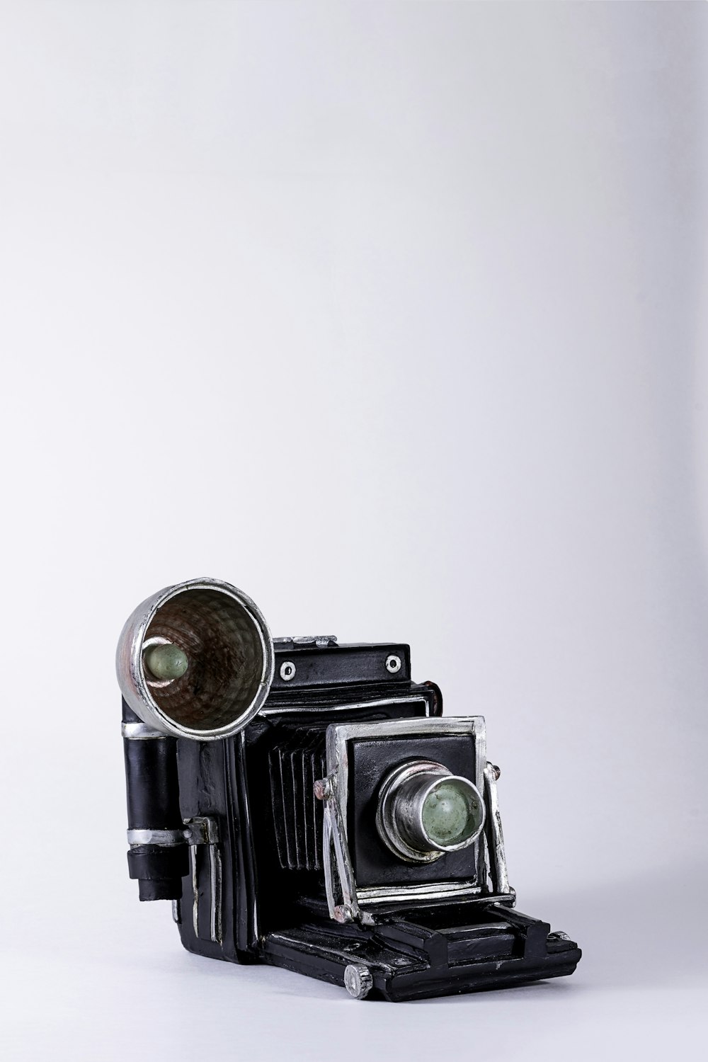 folding camera on white surface