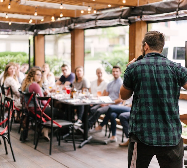 man standing infront of group of people