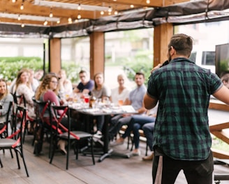 man standing infront of group of people