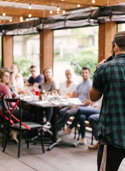 man standing infront of group of people