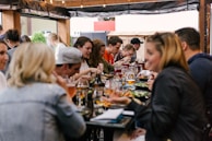 people sitting in front of table talking and eating