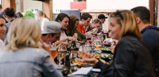 people sitting in front of table talking and eating