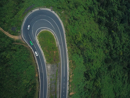 three vehicles on curved road in Đèo Hải Vân Vietnam