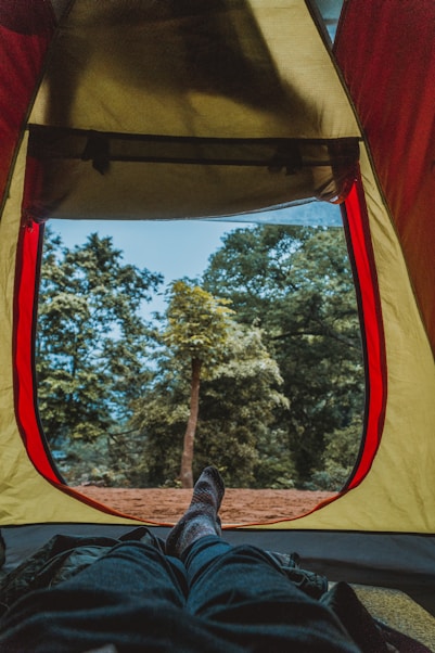 photo of man laying inside the tent