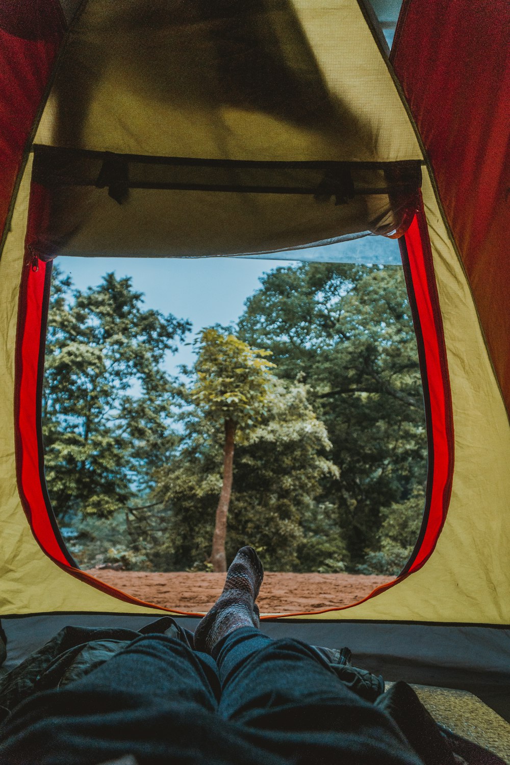 photo of man laying inside the tent