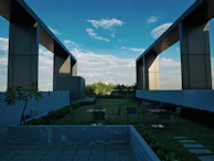 A rooftop garden atop a minimalist building blending with the skyline.