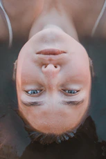 woman lying on body of water in closeup photography