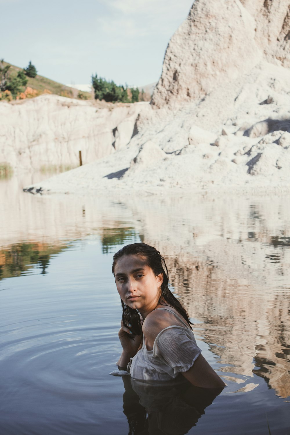 woman wearing white top soaking in water