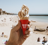 selective photo of person holding ice cream