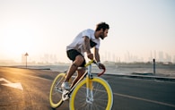 man riding bicycle on road during daytime