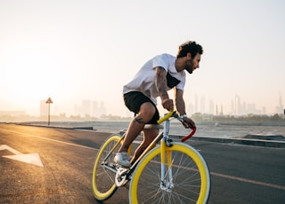 man riding bicycle on road during daytime