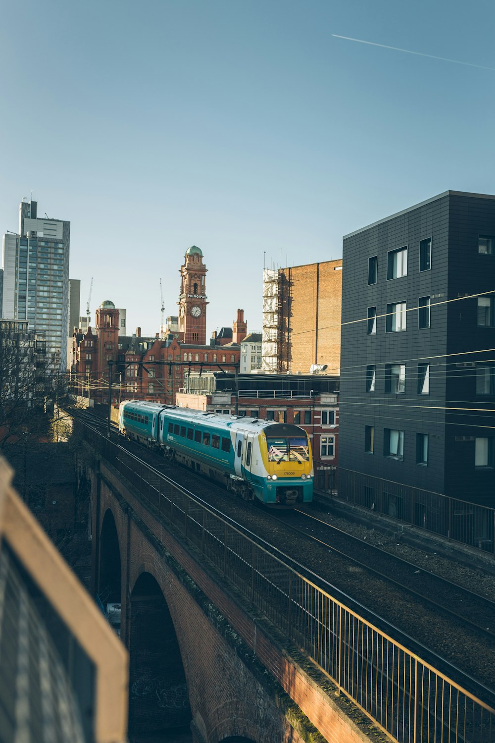 yellow and green train beside building