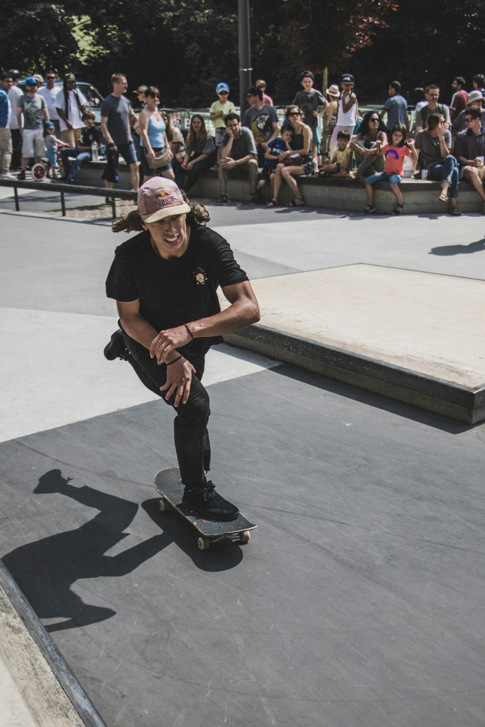 people watching man playing skateboard during daytime