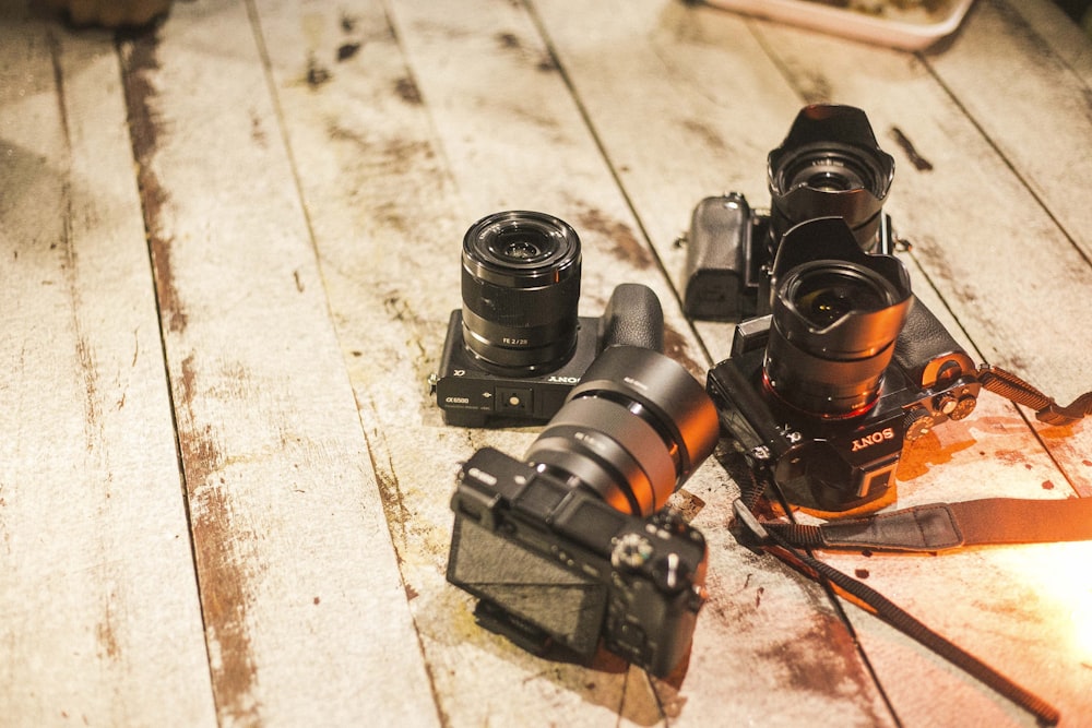 four DSLR cameras on floor