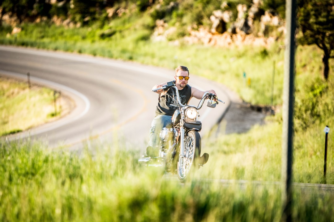 selective focus photography of man riding black chopper motorcycle