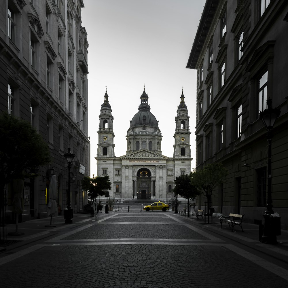 selective color of taxi near building at daytime