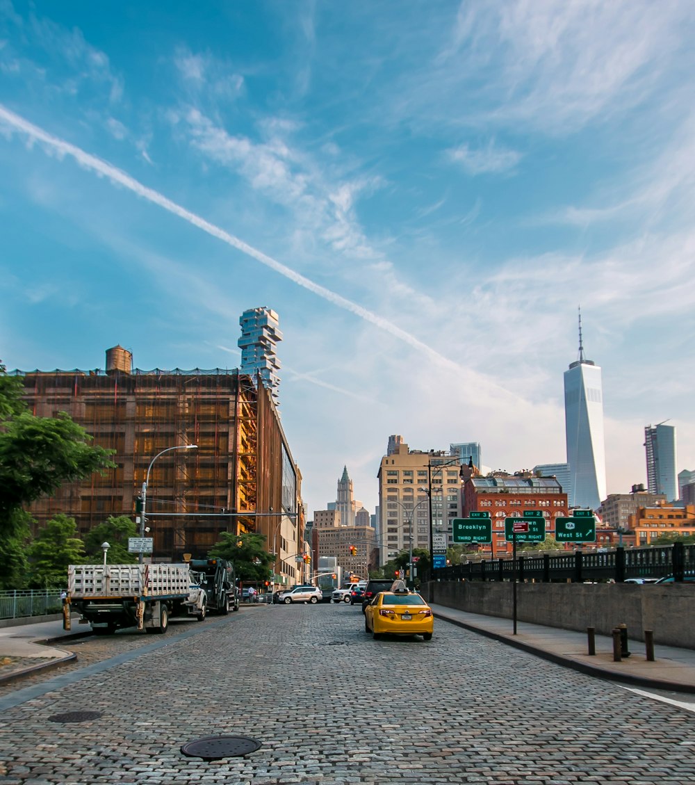 taxi cab on roadunder cloudy sky