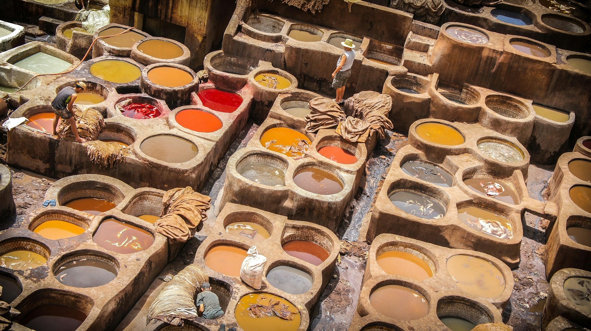 a table filled with lots of different colors of paint