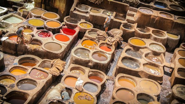A table filled with lots of different colors of paint — Fes, Morocco